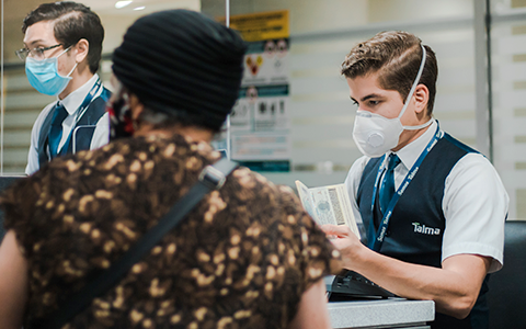 Check-in staff observing security measures