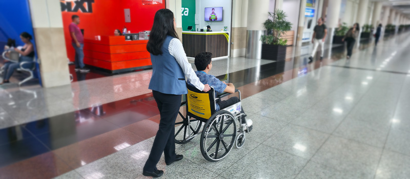 Staff assisting a passenger on a wheelchair.